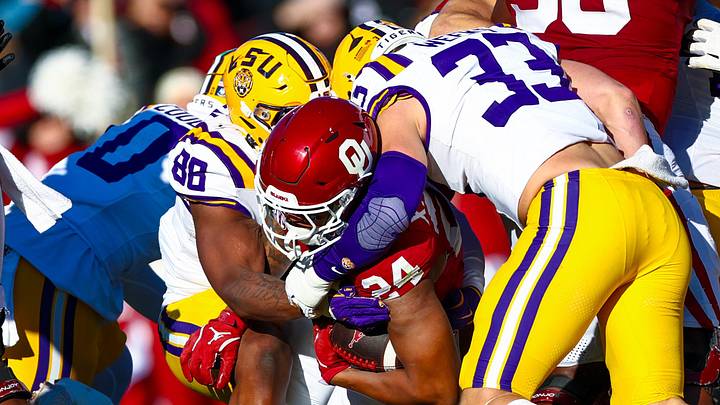 Nov 29, 2025; Norman, Oklahoma, USA; Louisiana State Tigers defensive lineman Bernard Gooden (88) and Louisiana State Tigers linebacker West Weeks (33) tackle Oklahoma Sooners running back Xavier Robinson (24) during the first half at Gaylord Family-Oklahoma Memorial Stadium. Mandatory Credit: Kevin Jairaj-Imagn Images Nov 29, 2025; Norman, Oklahoma, USA; Louisiana State Tigers defensive lineman Bernard Gooden (88) and Louisiana State Tigers linebacker West Weeks (33) tackle Oklahoma Sooners running back Xavier Robinson (24) during the first half at Gaylord Family-Oklahoma Memorial Stadium. Mandatory Credit: Kevin Jairaj-Imagn Images