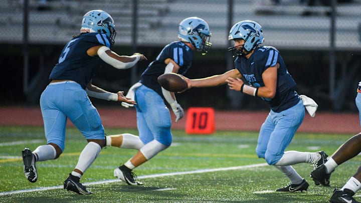 North Penn's Matthew Bucksar hands the ball off to Christian Johns-Wallace against Neshaminy during their game in Lansdale on Friday, Sept. 13, 2024. North Penn's Matthew Bucksar hands the ball off to Christian Johns-Wallace against Neshaminy during their game in Lansdale on Friday, Sept. 13, 2024.