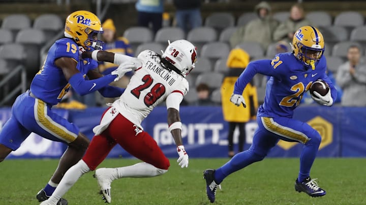 Oct 14, 2023; Pittsburgh, Pennsylvania, USA; Pittsburgh Panthers wide receiver Che Nwabuko (21) returns a punt against the Louisville Cardinals during the third quarter at Acrisure Stadium. Pittsburgh won 38-21.Mandatory Credit: Charles LeClaire-Imagn Images