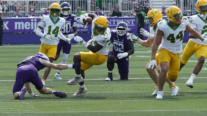 Sep 13, 2025; Evanston, Illinois, USA; Oregon Ducks linebacker Jerry Mixon (54) intercepts a pass against the Northwestern Wildcats during the second half at Northwestern Medicine Field at Martin Stadium. Mandatory Credit: David Banks-Imagn Images