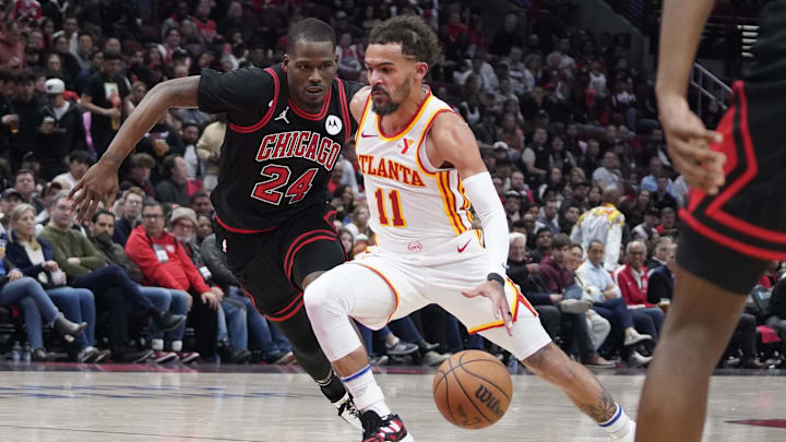 Apr 17, 2024; Chicago, Illinois, USA; Chicago Bulls guard Javonte Green (24) defends Atlanta Hawks guard Trae Young (11) during the second half during a play-in game of the 2024 NBA playoffs at United Center. Mandatory Credit: David Banks-USA TODAY Sports