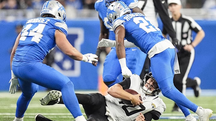 Nov 17, 2024; Detroit, MI, USA; Jacksonville Jaguars quarterback Mac Jones (10) slides against Detroit Lions cornerback Amik Robertson (21) and linebacker Malcolm Rodriguez (44) during the first half at Ford Field in Detroit on Sunday, Nov. 17, 2024. Mandatory Credit: Junfu Han/USA TODAY Network via Imagn Images Nov 17, 2024; Detroit, MI, USA; Jacksonville Jaguars quarterback Mac Jones (10) slides against Detroit Lions cornerback Amik Robertson (21) and linebacker Malcolm Rodriguez (44) during the first half at Ford Field in Detroit on Sunday, Nov. 17, 2024. Mandatory Credit: Junfu Han/USA TODAY Network via Imagn Images