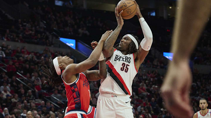 Jan 16, 2025; Portland, Oregon, USA; Portland Trail Blazers center Robert Williams III (35) grabs a rebound during the second half against LA Clippers guard Terance Mann (14) at Moda Center. Mandatory Credit: Troy Wayrynen-Imagn Images