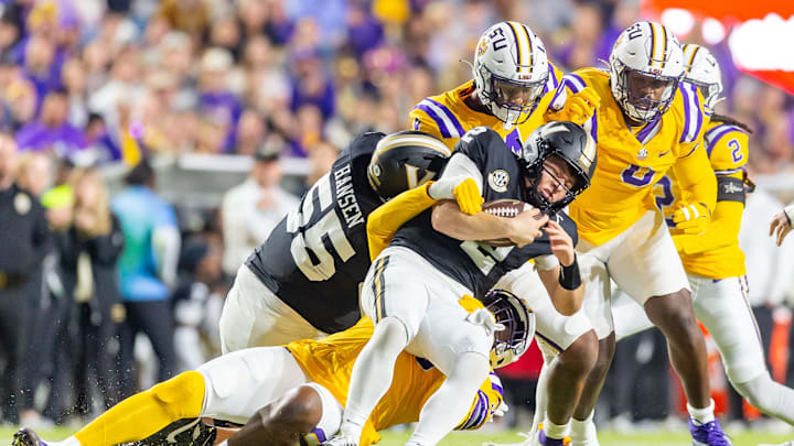 Diego Pavia 2 is sacked by Defensive end Sai'vion Jones 35 as the Tigers LSU Tigers take on the Vanderbilt Commodores. Nov 23, 2024; Baton Rouge, Louisiana, USA; at Tiger Stadium.
