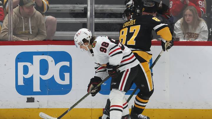 Apr 8, 2025; Pittsburgh, Pennsylvania, USA;  Chicago Blackhawks center Connor Bedard (98) and Pittsburgh Penguins center Sidney Crosby (87) battle for the puck during the second period at PPG Paints Arena. Mandatory Credit: Charles LeClaire-Imagn Images