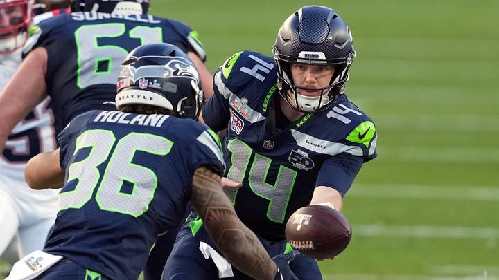 Feb 8, 2026; Santa Clara, CA, USA; Seattle Seahawks quarterback Sam Darnold (14) hands off to running back George Holani (36) during the first quarter against the New England Patriots in Super Bowl LX at Levi's Stadium. Mandatory Credit: Darren Yamashita-Imagn Images