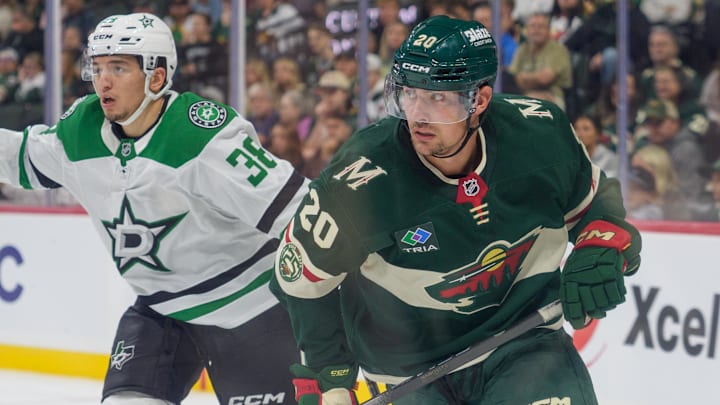 Sep 25, 2025; Saint Paul, Minnesota, USA; Minnesota Wild forward Brett Leason (20) and Dallas Stars defenseman Christian Kyrou (38) look for the puck down ice in the third period at Grand Casino Arena. Mandatory Credit: Matt Blewett-Imagn Images