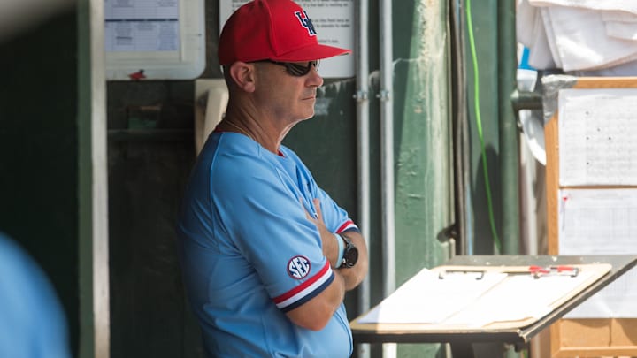 Jun 8, 2019; Fayetteville, AR, USA; Mississippi Rebels head coach Mike Bianco watches from the dugout during the game against the Arkansas Razorbacks at Baum-Walker Stadium. Mandatory Credit: Brett Rojo-Imagn Images