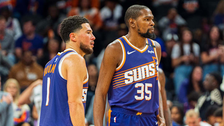 Nov 2, 2024; Phoenix, Arizona, USA;  Phoenix Suns guard Devin Booker (1) and forward Kevin Durant (35) react after a time out late in the second half during a game against the Portland Trail Blazers at Footprint Center. Mandatory Credit: Allan Henry-Imagn Images