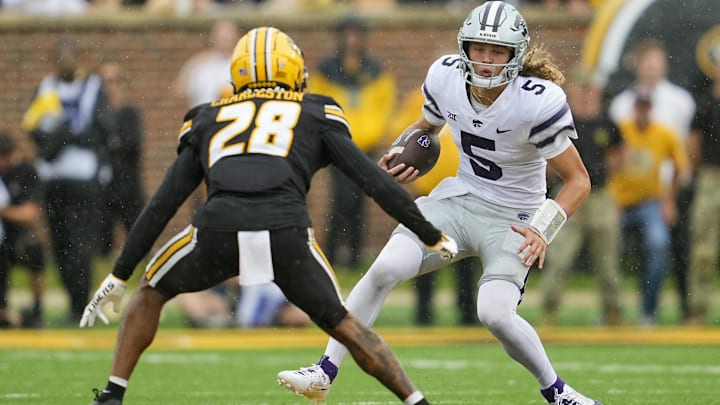 Sep 16, 2023; Columbia, Missouri, USA; Kansas State Wildcats quarterback Avery Johnson (5) runs the ball against Missouri Tigers defensive back Joseph Charleston (28) during the second half at Faurot Field at Memorial Stadium. Mandatory Credit: Jay Biggerstaff-Imagn Images