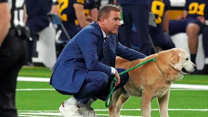Jan 8, 2024; Houston, TX, USA; ESPN analyst Kirk Herbstreit walks his dog Ben before the 2024 College Football Playoff national championship game between the Michigan Wolverines and the Washington Huskies at NRG Stadium