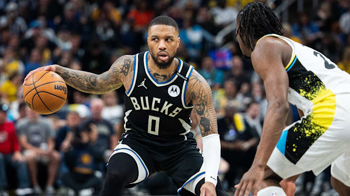 Apr 22, 2025; Indianapolis, Indiana, USA; Milwaukee Bucks guard Damian Lillard (0) dribbles the ball while Indiana Pacers forward Aaron Nesmith (23) defends during game two of first round for the 2024 NBA Playoffs at Gainbridge Fieldhouse. Mandatory Credit: Trevor Ruszkowski-Imagn Images Apr 22, 2025; Indianapolis, Indiana, USA; Milwaukee Bucks guard Damian Lillard (0) dribbles the ball while Indiana Pacers forward Aaron Nesmith (23) defends during game two of first round for the 2024 NBA Playoffs at Gainbridge Fieldhouse. Mandatory Credit: Trevor Ruszkowski-Imagn Images