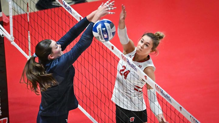 Wisconsin setter Charlie Fuerbringer (24) taps the ball around Marquette outside hitter Natalie Ring (17) in a spring match Wednesday, April 16, 2025, at the UW Field House in Madison, Wisconsin.