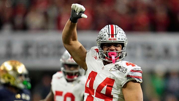 Ohio State Buckeyes defensive end JT Tuimoloau (44) celebrates tackling Notre Dame Fighting Irish quarterback Riley Leonard (13) during the College Football Playoff National Championship at Mercedes-Benz Stadium in Atlanta on January 20, 2025.