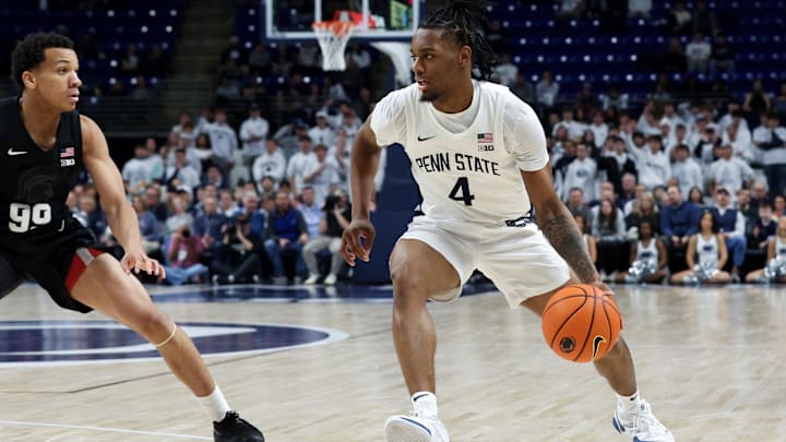 Penn State Nittany Lions guard Kayden Mingo (4) dribbles the ball toward the basket as Michigan State Spartans guard Divine Ugochukwu (99) defends during the first half at Bryce Jordan Center. 