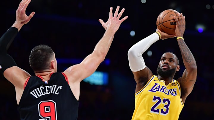 Jan 25, 2024; Los Angeles, California, USA; Los Angeles Lakers forward LeBron James (23) shoots against Chicago Bulls center Nikola Vucevic (9) during the first half at Crypto.com Arena. Mandatory Credit: Gary A. Vasquez-Imagn Images