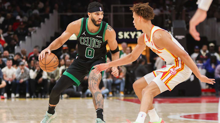Nov 4, 2024; Atlanta, Georgia, USA; Boston Celtics forward Jayson Tatum (0) is defended by Atlanta Hawks guard Dyson Daniels (5) in the second quarter at State Farm Arena. Mandatory Credit: Brett Davis-Imagn Images