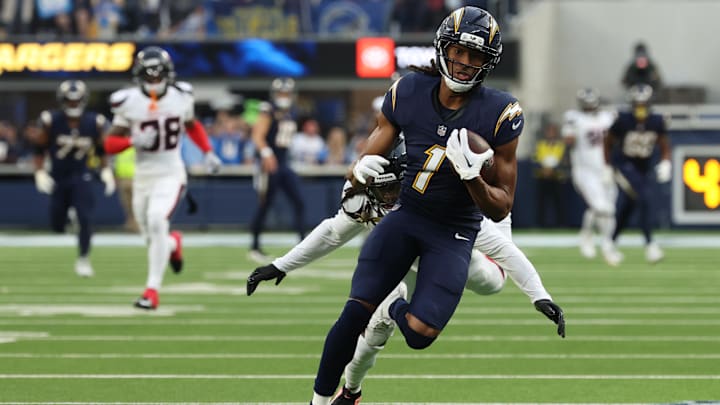 Dec 27, 2025; Inglewood, California, USA;  Los Angeles Chargers wide receiver Quentin Johnston (1) runs after the catch as Houston Texans cornerback Tremon Smith (11) defends during the first half at SoFi Stadium. Mandatory Credit: Kiyoshi Mio-Imagn Images