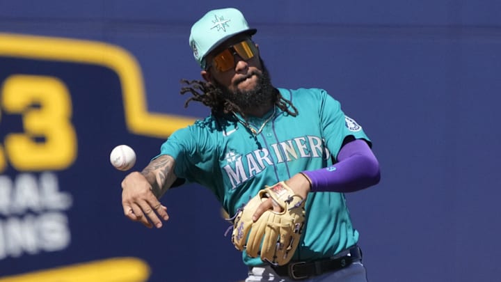 Mar 9, 2024; Phoenix, Arizona, USA; Seattle Mariners shortstop JP Crawford (3) flips the ball for an out against the Milwaukee Brewers in the third inning at American Family Fields of Phoenix. Mandatory Credit: Rick Scuteri-Imagn Images