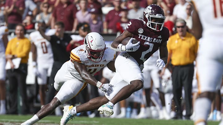 Louisiana Monroe Warhawks linebacker Travor Randle (4) attempts to tackle Texas A&M Aggies running back Rueben Owens (2) on a play during the second quarter at Kyle Field.