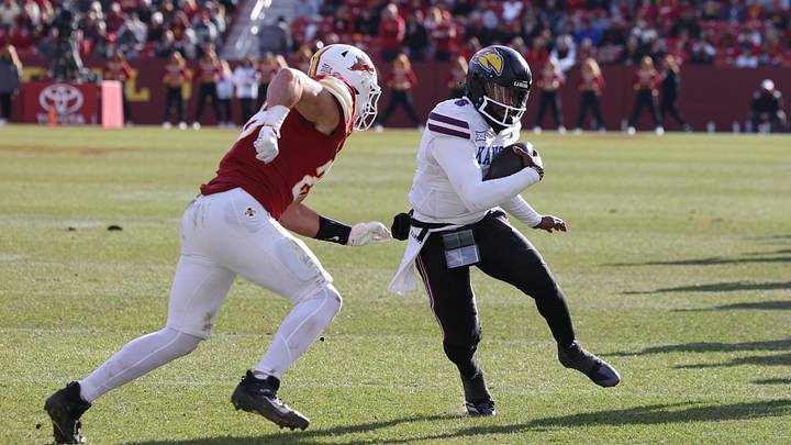 Kansas Jayhawks quarterback Jalon Daniels (6) is pursued by Iowa State Cyclones linebacker Caleb Bacon (26) during the second half at Jack Trice Stadium. 