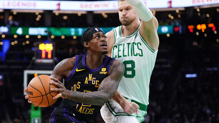 Feb 1, 2024; Boston, Massachusetts, USA; Los Angeles Lakers forward Jarred Vanderbilt (2) drives the ball against Boston Celtics center Kristaps Porzingis (8) in the first quarter at TD Garden. Mandatory Credit: David Butler II-Imagn Images