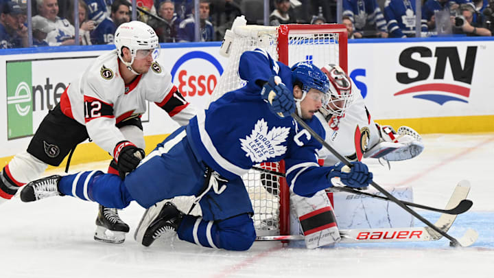 Apr 22, 2025; Toronto, Ontario, CAN;  Toronto Maple Leafs forward Auston Matthews (34) reaches for the puck as Ottawa Senators goalie Linus Ullmark (35) defends his goal in the third period in game two of the first round of the 2025 Stanley Cup Playoffs at Scotiabank Arena. Mandatory Credit: Dan Hamilton-Imagn Images