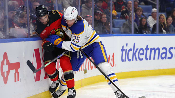 Buffalo Sabres defenseman Owen Power (25) checks Ottawa Senators defenseman Artem Zub (2) as he goes for a loose puck during the first period Oct 15, 2025; Buffalo, New York, USA;  at KeyBank Center. Mandatory Credit: Timothy T. Ludwig-Imagn Images