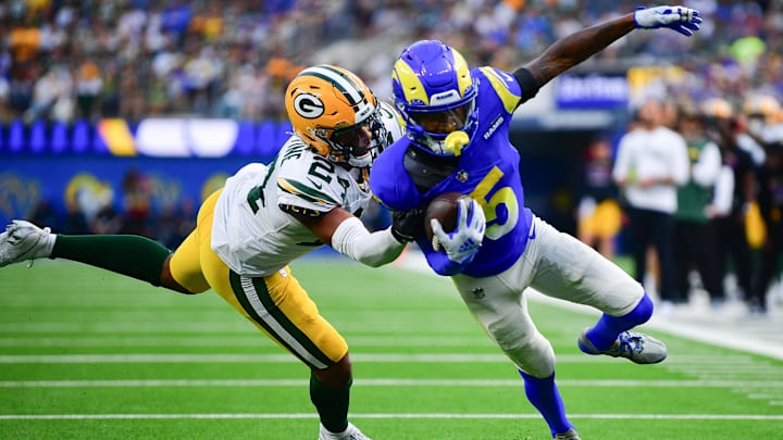Oct 6, 2024; Inglewood, California, USA; Los Angeles Rams wide receiver Tutu Atwell (5) runs the ball against Green Bay Packers cornerback Carrington Valentine (24) during the second half at SoFi Stadium. Mandatory Credit: Gary A. Vasquez-Imagn Images