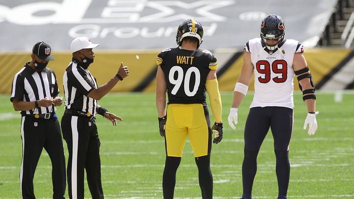 Sep 27, 2020; Pittsburgh, Pennsylvania, USA; NFL referee Shawn Smith (14) flips the coin as brothers Pittsburgh Steelers outside linebacker T.J. Watt (90) and Houston Texans defensive end J.J. Watt (99) take part before their game against at Heinz Field. The Steelers won 28-21. Mandatory Credit: Charles LeClaire-Imagn Images