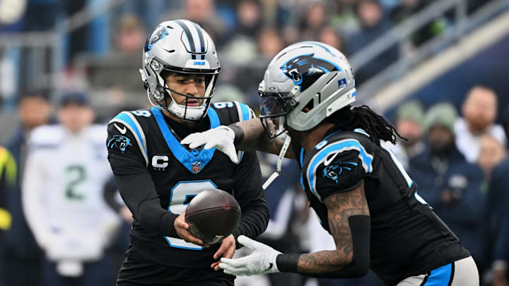Dec 28, 2025; Charlotte, North Carolina, USA; Carolina Panthers quarterback Bryce Young (9) hands the ball to running back Rico Dowdle (5) against the Seattle Seahawks during the first quarter at Bank of America Stadium. Mandatory Credit: Bob Donnan-Imagn Images