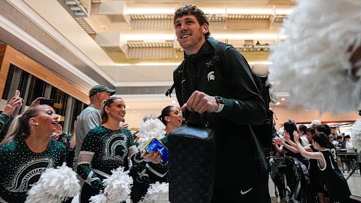 Michigan State guard Gehrig Normand (7) walks by Michigan State fans and cheerleaders during the team send-off of the Elite Eight round of NCAA tournament at Hyatt Regency in Atlanta, Ga. on Sunday, March 30, 2025.