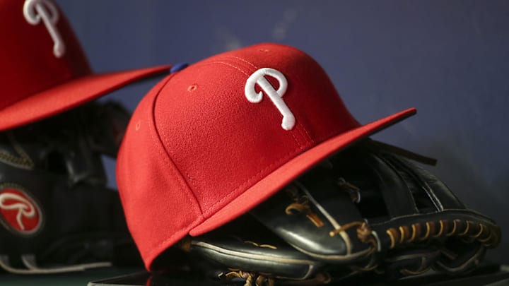 May 25, 2022; Atlanta, Georgia, USA; Detailed view of a Philadelphia Phillies hat and glove in the dugout against the Atlanta Braves in the eighth inning at Truist Park. Mandatory Credit: Brett Davis-Imagn Images