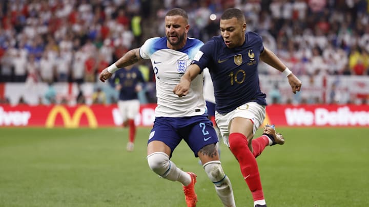 Dec 10, 2022; Al Khor, Qatar; England defender Kyle Walker (2) and France forward Kylian Mbapp   (10) chase the ball during the second half of a quarterfinal game in the 2022 FIFA World Cup at Al-Bayt Stadium. Mandatory Credit: Yukihito Taguchi-Imagn Images
