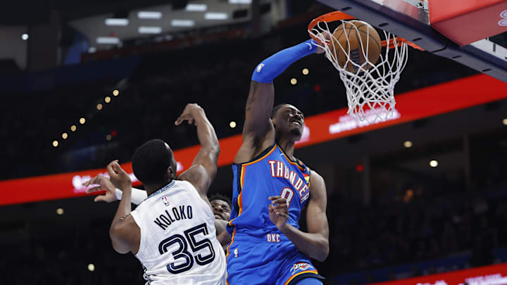 Dec 22, 2025; Oklahoma City, Oklahoma, USA; Oklahoma City Thunder guard Jalen Williams (8) dunks over Memphis Grizzlies Christian Koloko (35) during the second half at Paycom Center. Mandatory Credit: Alonzo Adams-Imagn Images