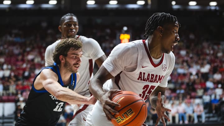Nov 4, 2024; Tuscaloosa, Alabama, USA; Alabama Crimson Tide forward Derrion Reid (35) controls the ball against North Carolina-Asheville Bulldogs guard Fletcher Abee (12) during the first half at Coleman Coliseum. Mandatory Credit: Will McLelland-Imagn Images