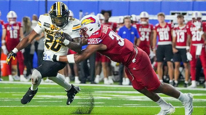Sep 11, 2026; Lawrence, Kansas, USA; Missouri Tigers running back Jamal Roberts (20) runs the ball as Kansas Jayhawks defensive end Leroy Harris III (33) makes the tackle during the second half of the game at David Booth Kansas Memorial Stadium. Mandatory Credit: Denny Medley-Imagn Images Sep 11, 2026; Lawrence, Kansas, USA; Missouri Tigers running back Jamal Roberts (20) runs the ball as Kansas Jayhawks defensive end Leroy Harris III (33) makes the tackle during the second half of the game at David Booth Kansas Memorial Stadium. Mandatory Credit: Denny Medley-Imagn Images