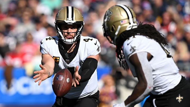 Oct 8, 2023; Foxborough, Massachusetts, USA; New Orleans Saints quarterback Derek Carr (4) hands the ball off to running back Alvin Kamara (41) during the second half at Gillette Stadium. Mandatory Credit: Brian Fluharty-USA TODAY Sports