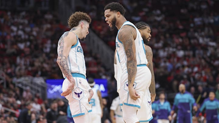 Oct 23, 2024; Houston, Texas, USA; Charlotte Hornets forward Miles Bridges (0) celebrates with guard LaMelo Ball (1) after scoring a basket during the fourth quarter against the Houston Rockets at Toyota Center. Mandatory Credit: Troy Taormina-Imagn Images