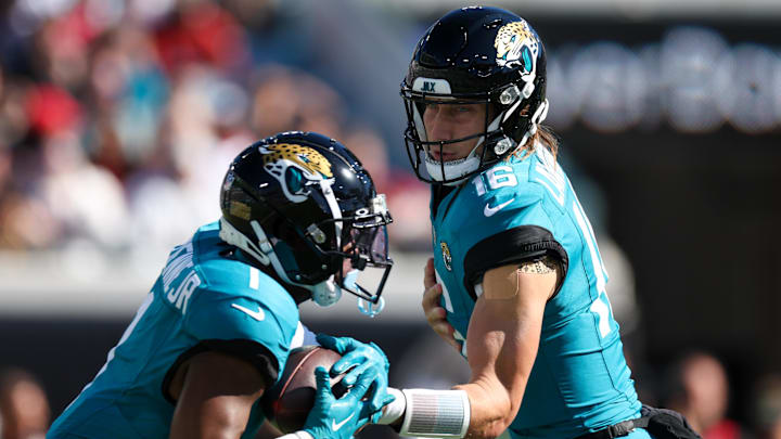 Dec 1, 2024; Jacksonville, Florida, USA; Jacksonville Jaguars quarterback Trevor Lawrence (16) hands off to running back Travis Etienne Jr. (1) against the Houston Texans in the first quarter at EverBank Stadium. Mandatory Credit: Nathan Ray Seebeck-Imagn Images Dec 1, 2024; Jacksonville, Florida, USA; Jacksonville Jaguars quarterback Trevor Lawrence (16) hands off to running back Travis Etienne Jr. (1) against the Houston Texans in the first quarter at EverBank Stadium. Mandatory Credit: Nathan Ray Seebeck-Imagn Images