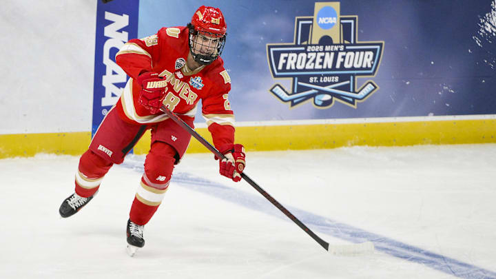 Apr 10, 2025; St. Louis, Missouri, UNITED STATES; Denver Pioneers defenseman Zeev Buium (28) controls the puck against the Western Michigan Broncos during the first period of the Frozen Four college ice hockey national semifinals at Enterprise Center. Mandatory Credit: Jeff Curry-Imagn Images