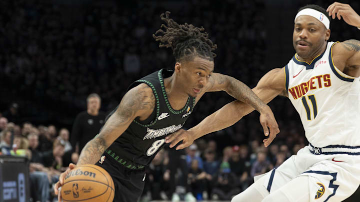 Apr 30, 2026; Minneapolis, Minnesota, USA; Minnesota Timberwolves guard Bones Hyland (8) dribbles the ball past Denver Nuggets guard Bruce Brown (11) in the first half during game six of the first round of the 2026 NBA Playoffs at Target Center. Mandatory Credit: Jesse Johnson-Imagn Images