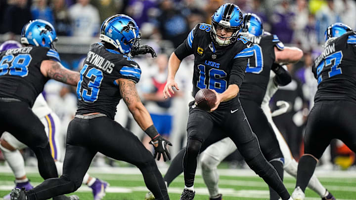 Detroit Lions quarterback Jared Goff (16) hands the ball to running back Craig Reynolds (13) against Minnesota Vikings during the first half at Ford Field in Detroit on Sunday, Jan. 5, 2025.