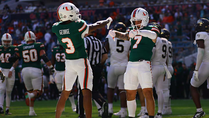 Nov 23, 2024; Miami Gardens, Florida, USA; Miami Hurricanes wide receiver Jacolby George (3) celebrates with Miami Hurricanes wide receiver Xavier Restrepo (7) after scoring a touchdown against the Wake Forest Demon Deacons during the first quarter at Hard Rock Stadium. Mandatory Credit: Sam Navarro-Imagn Images
