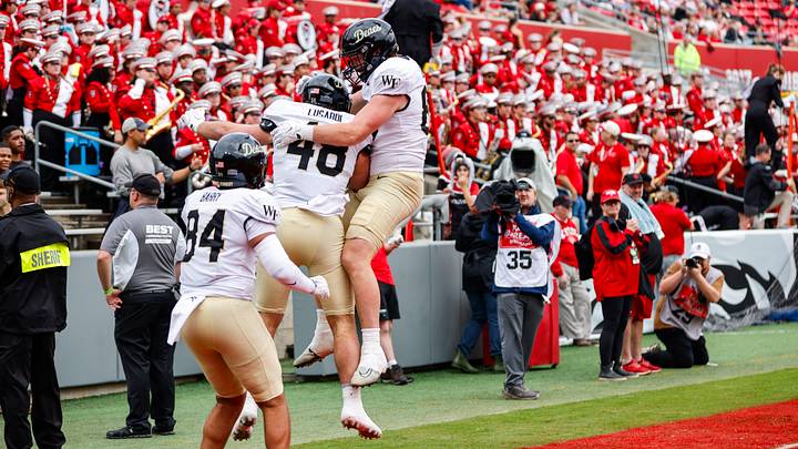 Oct 10, 2026; Raleigh, North Carolina, USA;  Wake Forest Demon Deacons tight end Matthew Lusardi (48) celebrates his touchdown with tight end Dominick Barry (84) and defensive back Koredell Bartley (35) during the first half of the game against NC State Wolfpack at Carter-Finley Stadium.  Mandatory Credit: Jaylynn Nash-Imagn Images