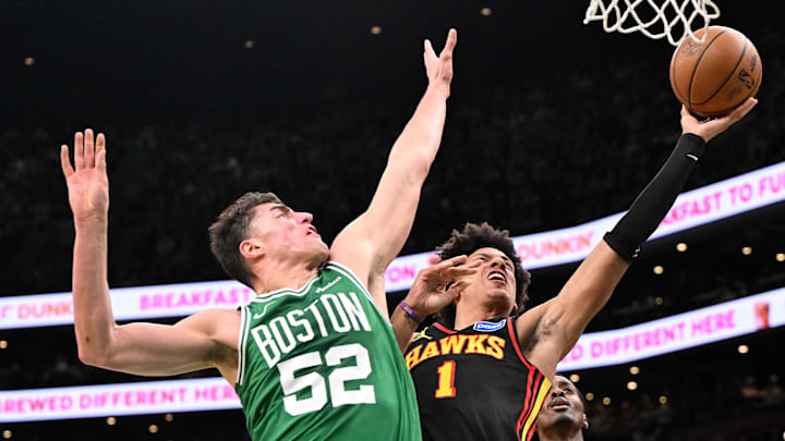 Jan 28, 2026; Boston, Massachusetts, USA; Boston Celtics center Luka Garza (52) defends Atlanta Hawks forward Jalen Johnson (1) during the first half at the TD Garden. Mandatory Credit: Brian Fluharty-Imagn Images