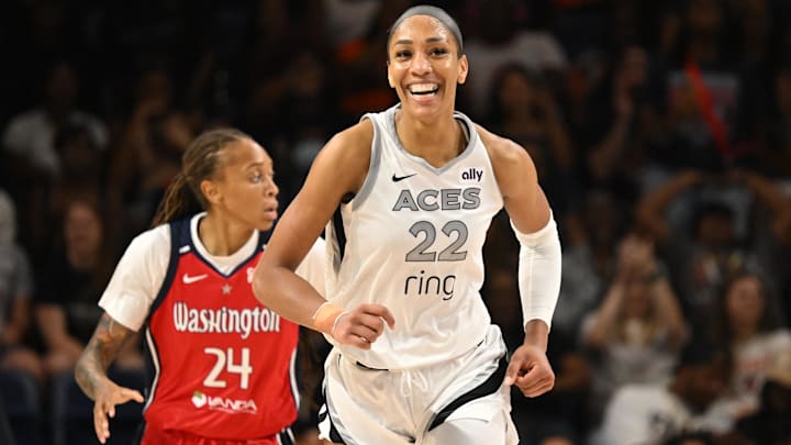 Aug 23, 2025; Washington, District of Columbia; Las Vegas Aces center A'ja Wilson (22) is all smiles after a basket against the Washington Mystics during the fourth quarter at CareFirst Arena. Aug 23, 2025; Washington, District of Columbia; Las Vegas Aces center A'ja Wilson (22) is all smiles after a basket against the Washington Mystics during the fourth quarter at CareFirst Arena.