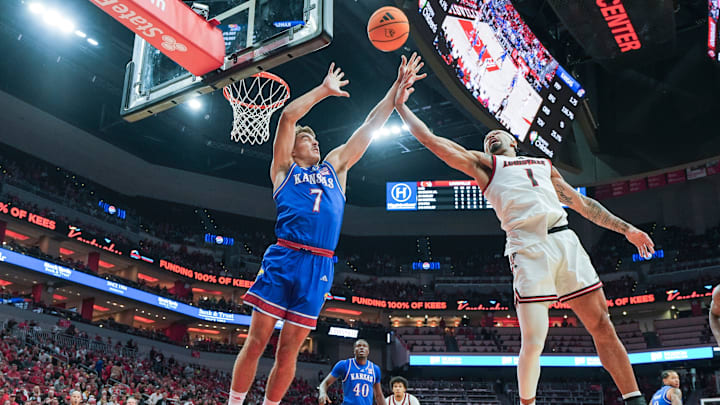 Kansas Jayhawks guard Kohl Rosario (7) battles Louisville Cardinals guard J'Vonne Hadley (1) for rebound during an exhibition game at the KFC Yum! Center in Louisville, Kentucky Friday, October 24, 2025. Kansas Jayhawks guard Kohl Rosario (7) battles Louisville Cardinals guard J'Vonne Hadley (1) for rebound during an exhibition game at the KFC Yum! Center in Louisville, Kentucky Friday, October 24, 2025.