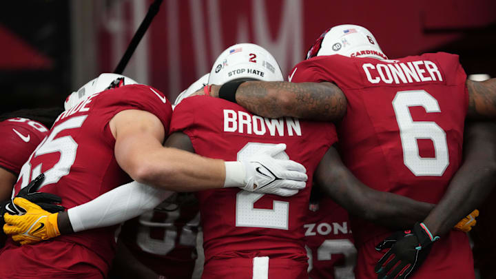 Arizona Cardinals players Trey McBride (85), Marquise Brown (2) and James Conner (6) huddle up before their game against the Atlanta Falcons at State Farm Stadium on Nov. 12, 2023, in Glendale.