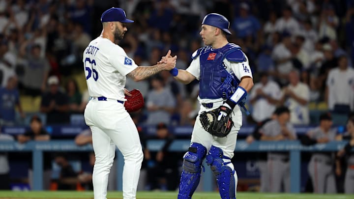 Sep 19, 2025; Los Angeles, California, USA;  Los Angeles Dodgers relief pitcher Tanner Scott (66) and catcher Dalton Rushing (68) celebrate a win after defeating the San Francisco Giants 6-3 at Dodger Stadium. Mandatory Credit: Kiyoshi Mio-Imagn Images